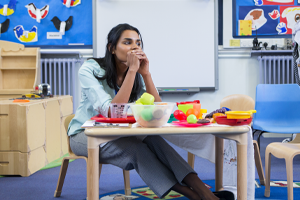 practitioner sat in nursery thinking concerned looking