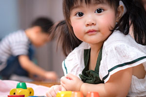 smiling little girl leaning on her elbows